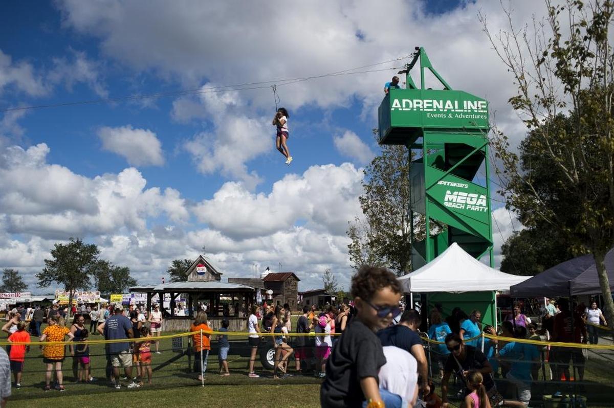 Children fly down the zip line during a past Hunsader Farms Pumpkin Festival.