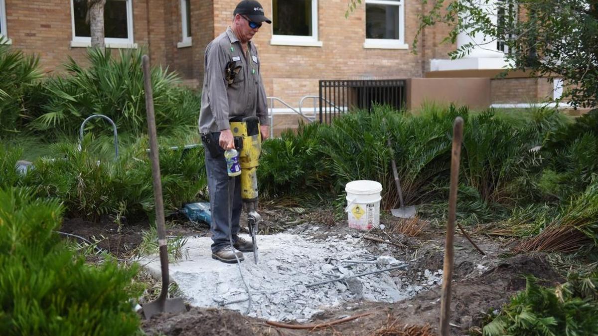 Roger Waldron, with Manatee County property management, takes a break Friday from jackhammering the remaining foundation where the Confederate statue once stood outside of the historic courthouse. The statue was removed in the early hours of Thursday.
