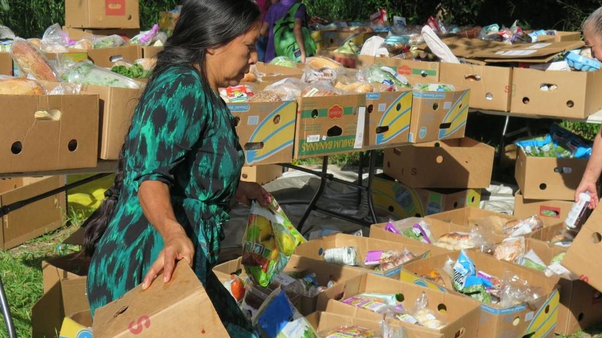 Catarina Gonzalez, 57, of Bradenton, helps organize boxes of food Monday behind Pentecost Church Christ Is Coming in Bradenton. Church members helped distribute food donated by Meals on Wheels PLUS of Manatee.