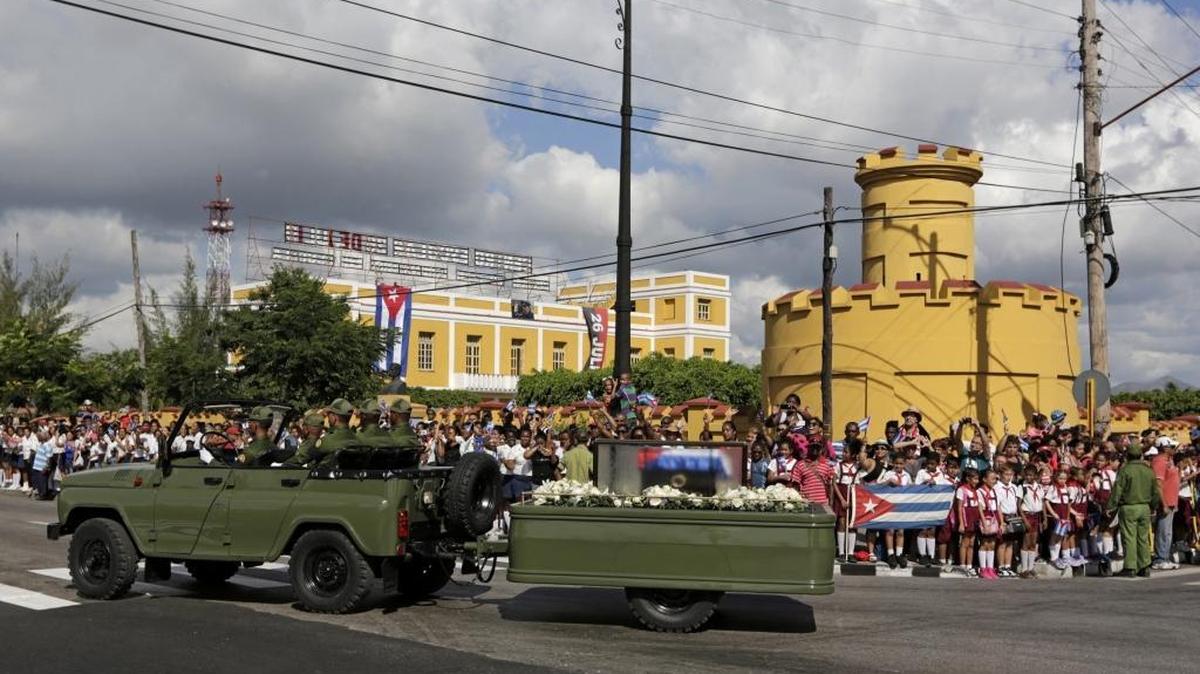 Cubans watch as the ashes of Fidel Castro's pass outside the Moncada Barracks, in Santiago de Cuba.