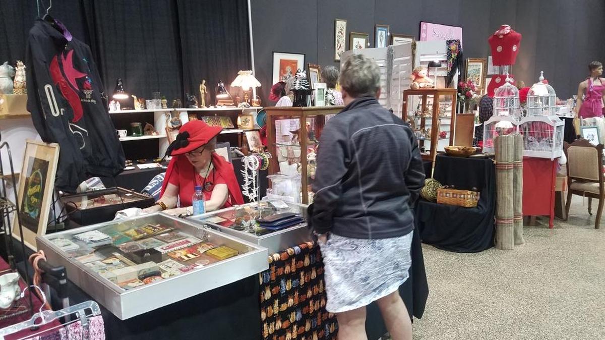 Karol Atkinson makes a sale at the Service Club of Manatee County’s 52nd annual Charity Antiques, Vintage and Collectibles Market in the Bradenton Area Convention Center on Saturday.