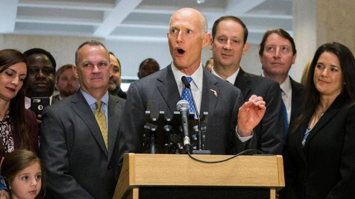 Florida Gov. Rick Scott speaks after the end of the legislative session at the Florida State Capitol in Tallahassee, March 11, 2018. Flanking Scott is Speaker of the House Richard Corcoran, left, and Senate President Joe Negron and Sen. Bill Galvano, R-Bradenton.