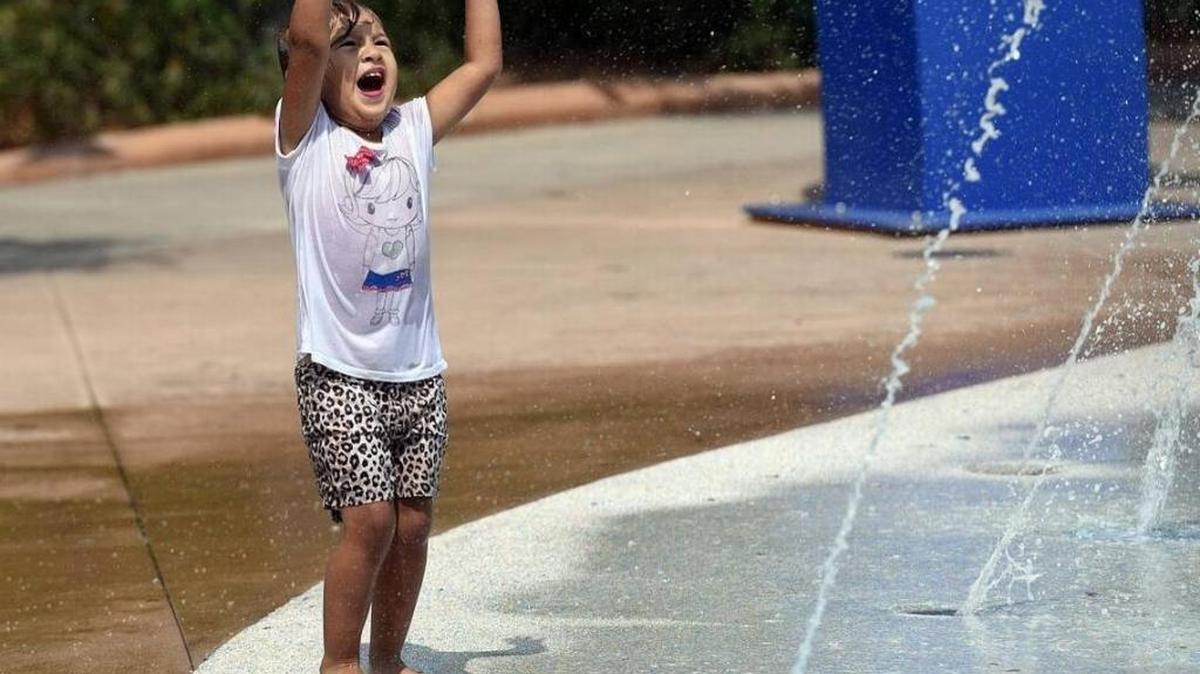 Scarlett Campa, 3, plays on Riverwalk's splash park.