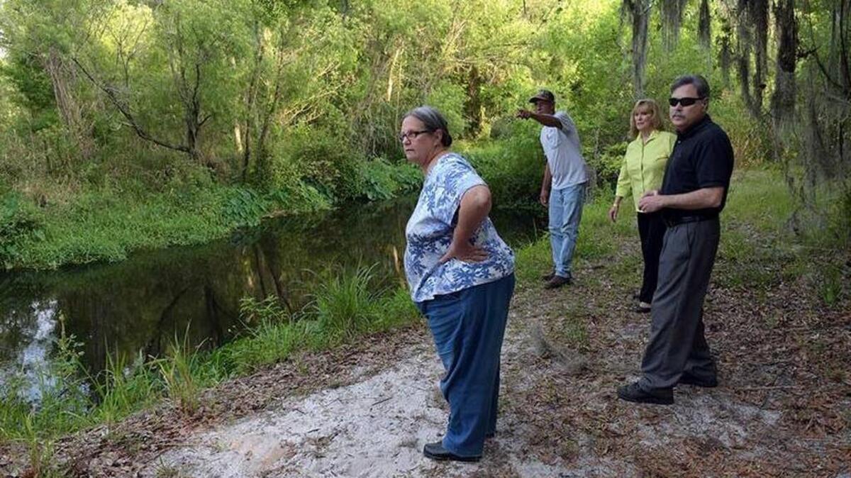Braden Woods residents walk along the Braden River on Carl Bergstresser’s property in this file photo. The group are part of a larger group who are working to preserve wooded area.