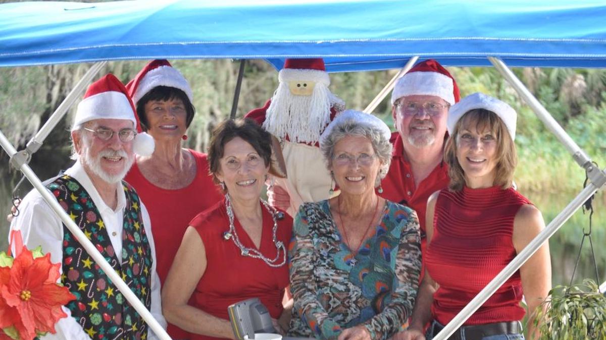 Members of the Old Braden River Historical Society sit inside of the boat they decorated for the 1st Annual Braden River Boat Parade.