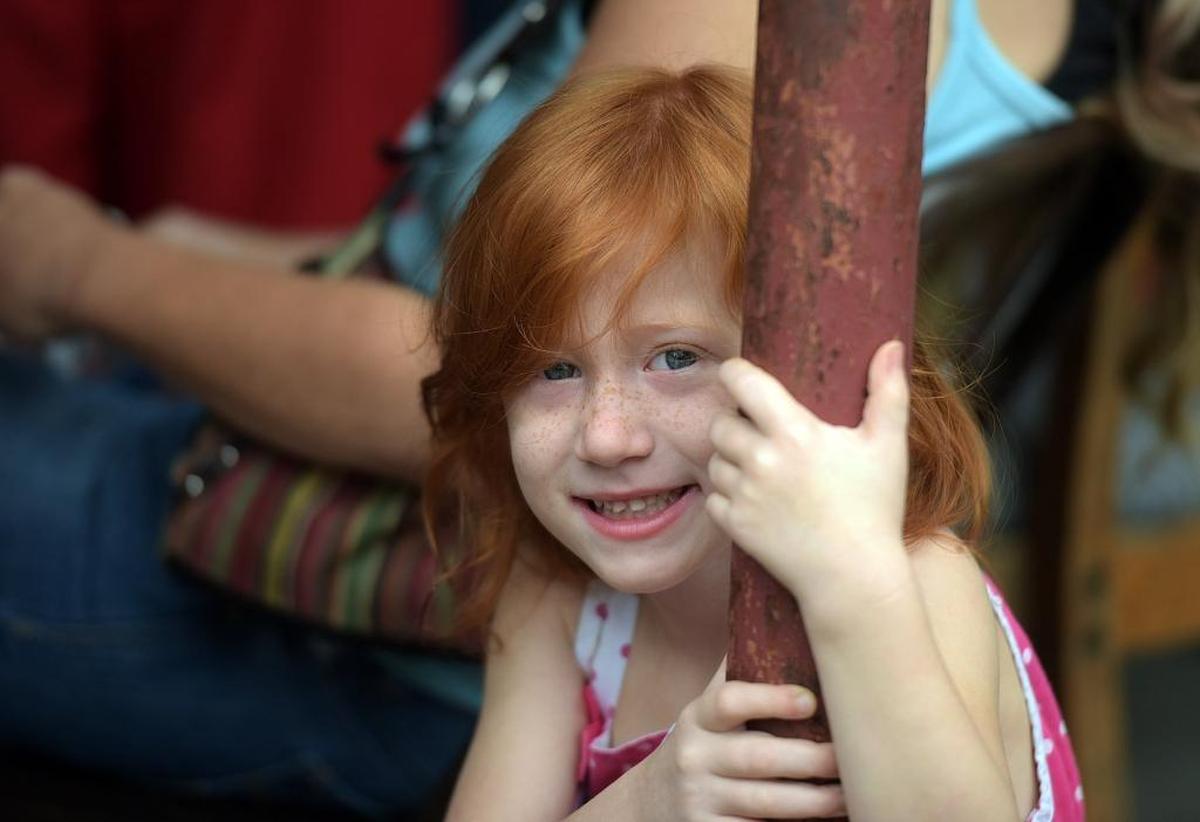 A young girls smiles at the Mt. Carmel Resource Center where the Palmetto Police Department teamed up with Mayors’ Feed the Hungry to collect food and distribute it to needy members of the community Tuesday morning. Other volunteers included high school students, Chief William Tokajer of Holmes Beach and Sheriff Rick Wells.