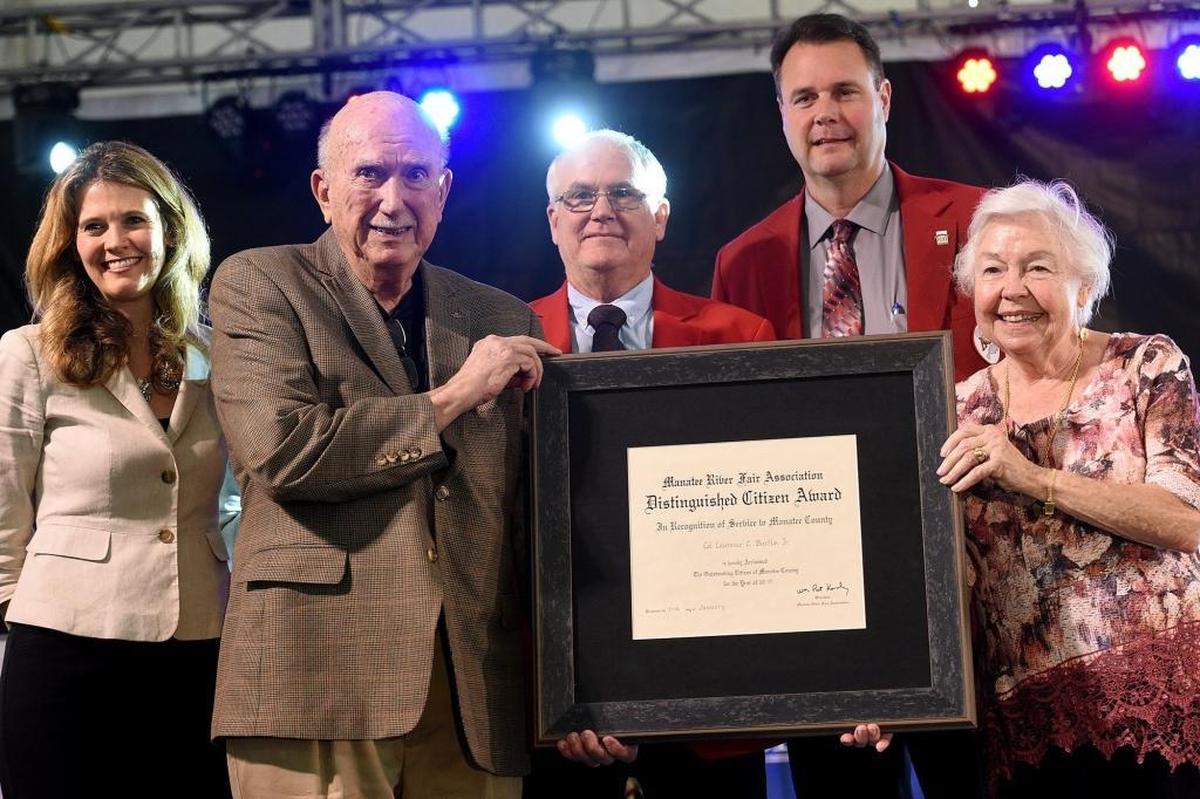 Larry Bustle, with wife Edie, was named the distinguished citizen at the Manatee County Fair on Thursday. Back: Janelle Esposito, Pat Kennedy and Dan West.