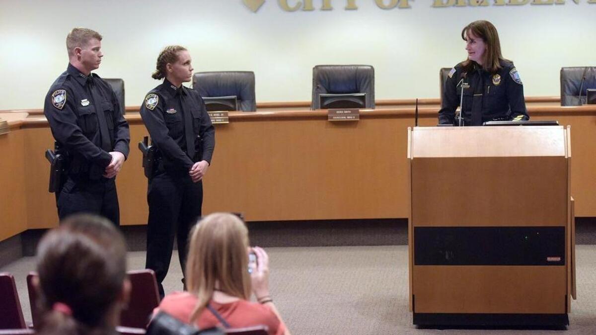 Two new Bradenton police officers, Steven Kalchbrenner and Hannah Moise, prepare to take the oath of office as Chief Melanie Bevan gives an address to the crowd Wednesday at City Hall.