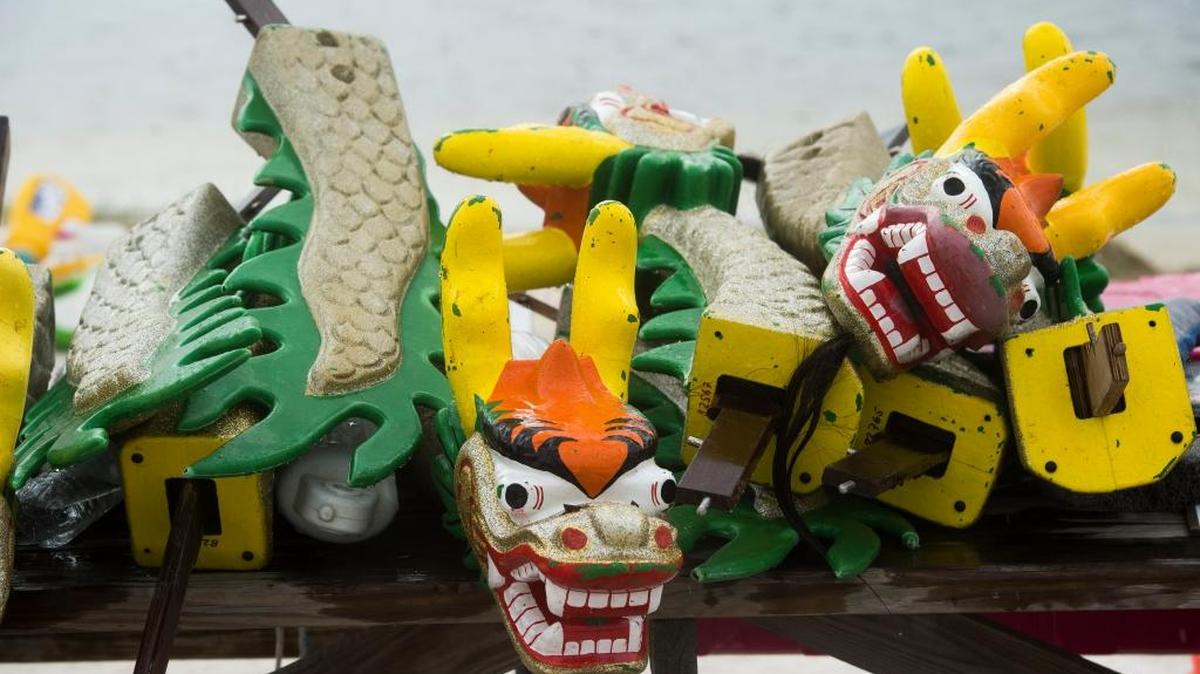 Decorative dragons are piled on a picnic table during the Suncoast International Dragon Boat Festival on Saturday afternoon at Nathan Benderson Park in Sarasota. Dragon Boat Racing is a competitive team rowing sport comprising 20 rowers and two drummers to maintain the rhythm of rowing. The sport traces its roots back to ancient southern China more than 2,000 years ago.