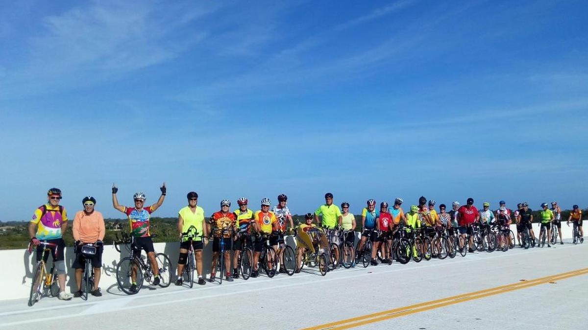 A group of cyclists pause atop the Fort Hamer Bridge. Sunday, the 43rd annual CycleFest will take riders across the bridge in East Manatee.