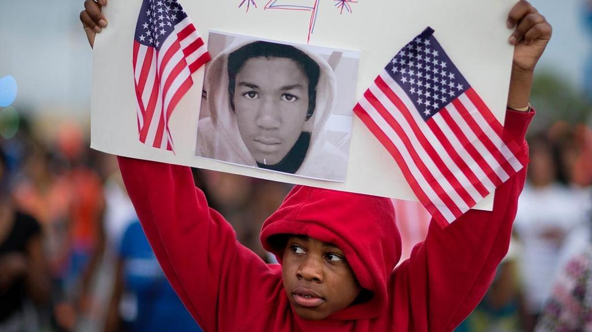 Jaylen Reese, 12, of Atlanta, marches to downtown during a protest of George Zimmerman’s not-guilty verdict in the 2012 shooting death of teenager Trayvon Martin, Monday, July 15, 2013, in Atlanta. Florida Memorial University will award a posthumous bachelor’s degree in aeronautical science to Martin on May 13.