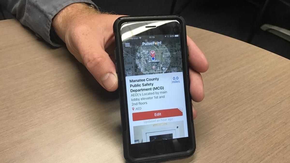 Jacob Saur, chief of emergency communications 911 in Manatee County, shows what registering an AED on the PulsePoint app looks like. He hopes community members will register nearby AEDs to build the app's local database.