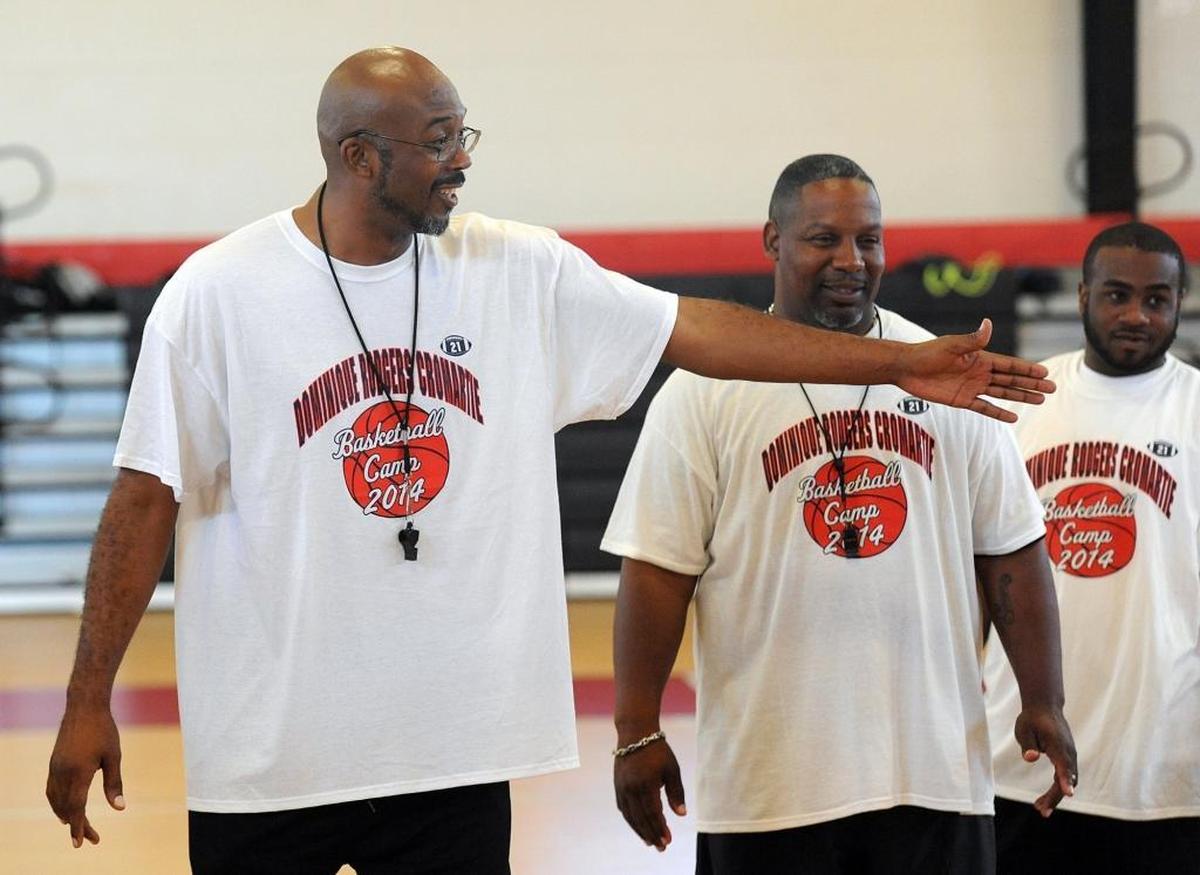 Palmetto High head boys basketball coach Reggie Bellamy works with young players attending the DRC Foundation Summer Basketball Camp at the Palmetto Boys and Girls Club.