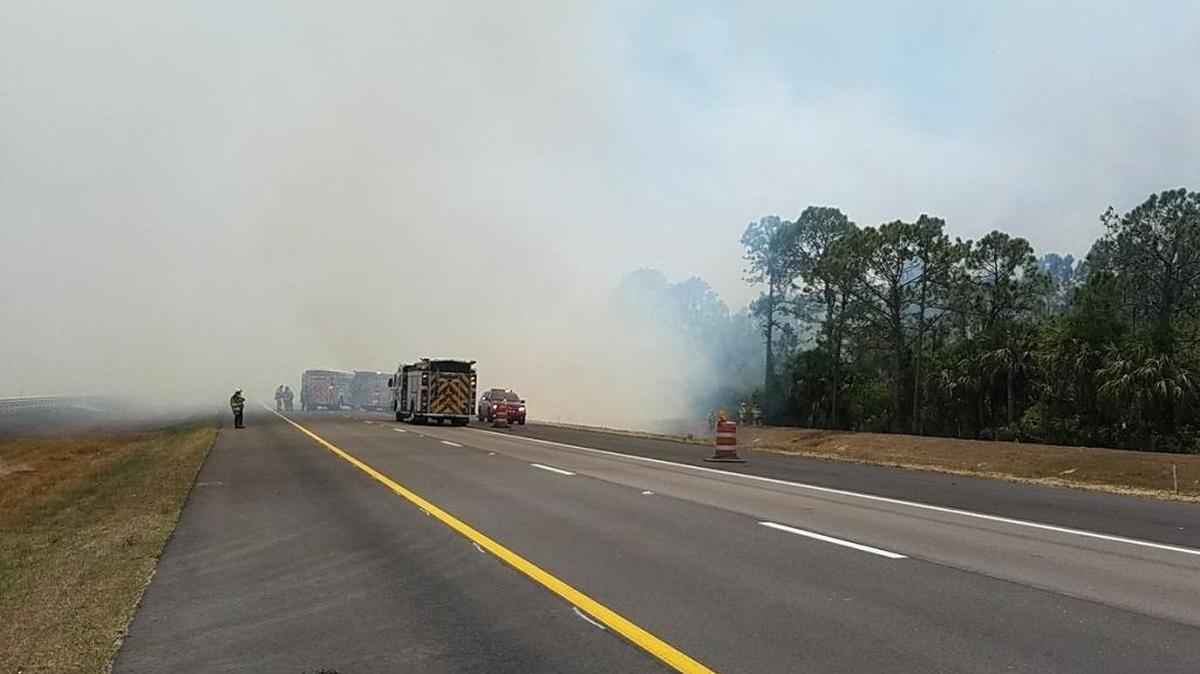 Firefighters are stopped along a smoked-covered Interstate 75 in North Port Saturday afternoon.