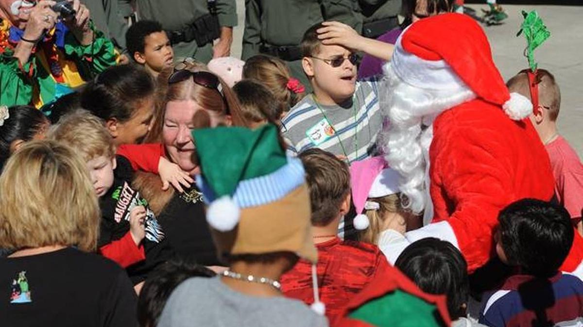 In this file photo, children and adults greet Santa at the 30th annual Flight to the North Pole program Thursday at the Sarasota-Bradenton International Airport Fire Department.