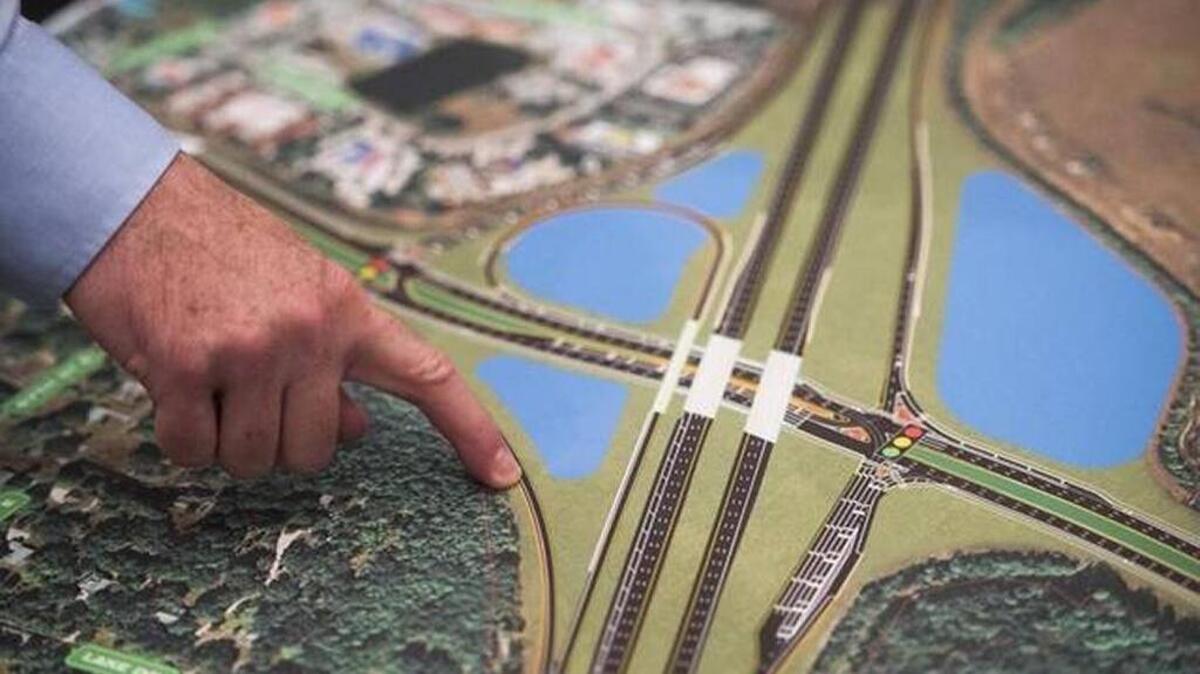 An official points to a map as locals gather for a public meeting to discuss Florida Department of Transportation’s expansion about improvements planned for Interstate 75 at State Road 64 interchange.