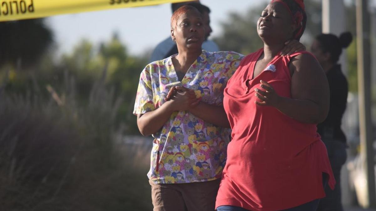 Kesha Martin, left, holds Rosemary Randolph as she reacts to the news of the death of 30-year-old Dequan Randolph after he was shot in the early hours of Thursday. Martin is Dequan’s cousin and Rosemary is his wife.