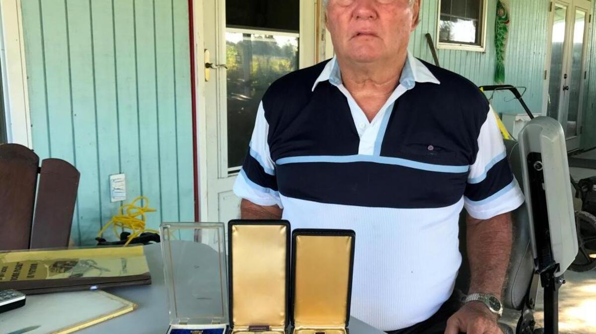 Robert Graves displays the two Purple Hearts awarded to him for wounds suffered in Vietnam, along with the Army Commendation Medal with V Device.