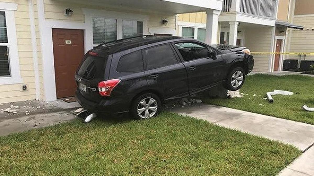 A car rests on a porch of a Sarasota apartment building Sunday morning.