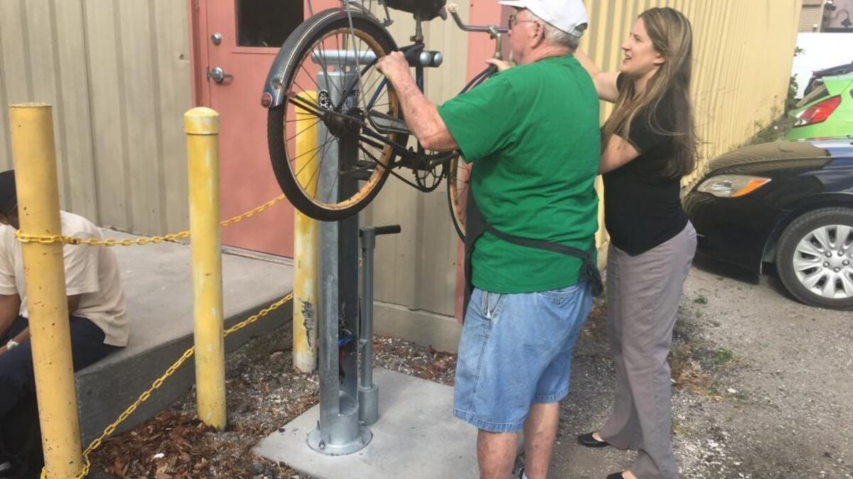 Jim Hassett, left, and Margi Dawson of Turning Points train themselves on the new Bicycle Repair Station a donor recently purchased for needy clients. The repair station is free and available to the public basically at any time on the Turning Point grounds, 701 17th Ave. W., Bradenton.