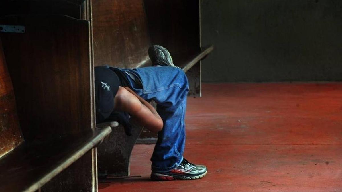 A homeless man sleeps on a bench at Turning Points. While new numbers appear to show homeless prevention efforts are working across the country, Manatee and Sarasota numbers continue to rise.