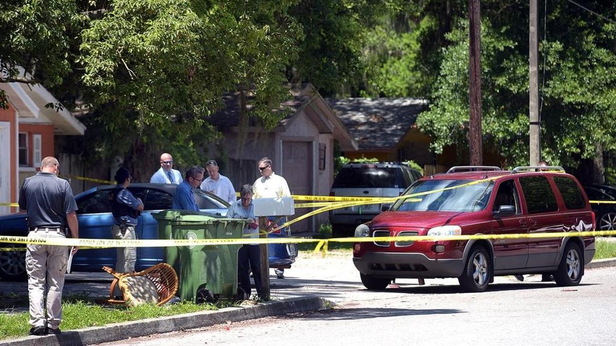 Detectives investigate the scene where two people were shot July 6 in Bradenton.