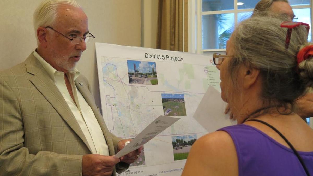 Manatee County Administrator Ed Hunzeker speaks with resident Linda Neely during the Oct. 4, 2016 half-cent sales tax meeting in Lakewood Ranch.