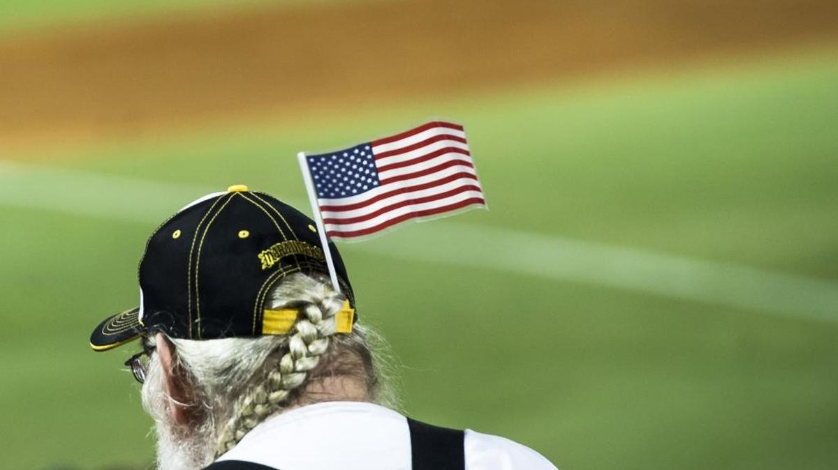 Baseball fans sport American flags as they watch the Bradenton Marauders take on the Florida Fire Frogs as they wait for the postgame fireworks on Saturday at LECOM Park in Bradenton.