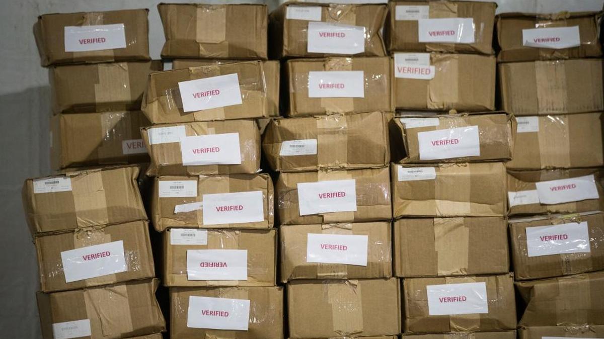 Boxes of debit cards are stacked inside a tent at Plant City Stadium in Plant City on Oct. 9 to be distributed as part of the Food for Florida disaster relief program.