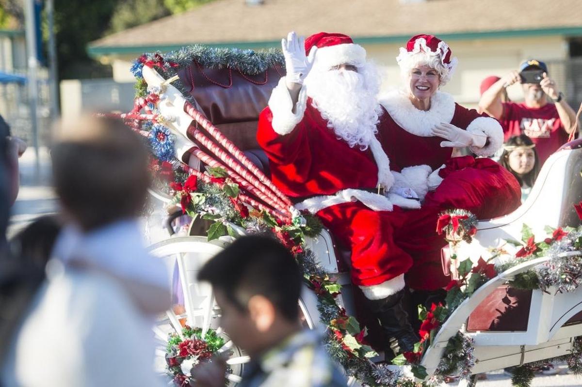 12/3/2016--Santa and Mrs. Claus wave to a crowd of excited children as they arrive on their sleigh to the “A Night Before Christmas” celebration at G.T. Bray Park in Bradenton.