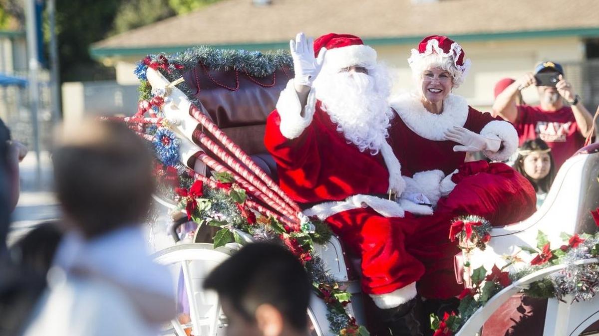 12/3/2016--Santa and Mrs. Claus wave to a crowd of excited children as they arrive on their sleigh to the “A Night Before Christmas” celebration at G.T. Bray Park in Bradenton.