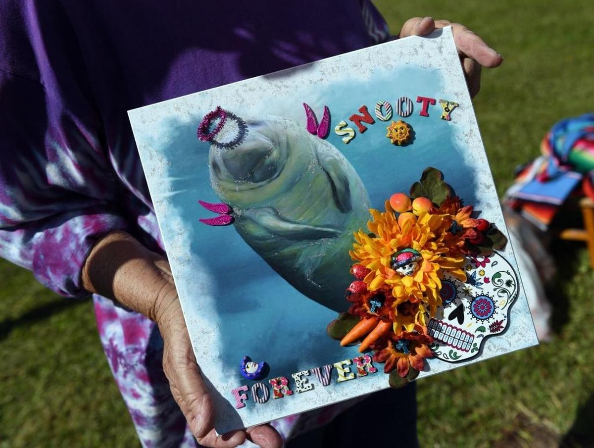 Zoe VonAverkamp holds a piece of artwork to be placed on a Snooty shrine.