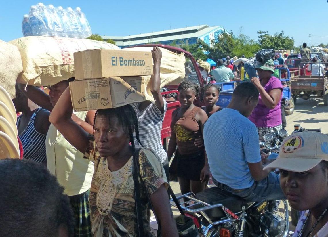 As pedestrians fight their way through a chaotic crowd of vendors and motorcycles and wheelbarrows laden with goods on the Ouanaminthe-Dajabón border in northeast Haiti, child protection workers monitor the movement looking for child traffickers.