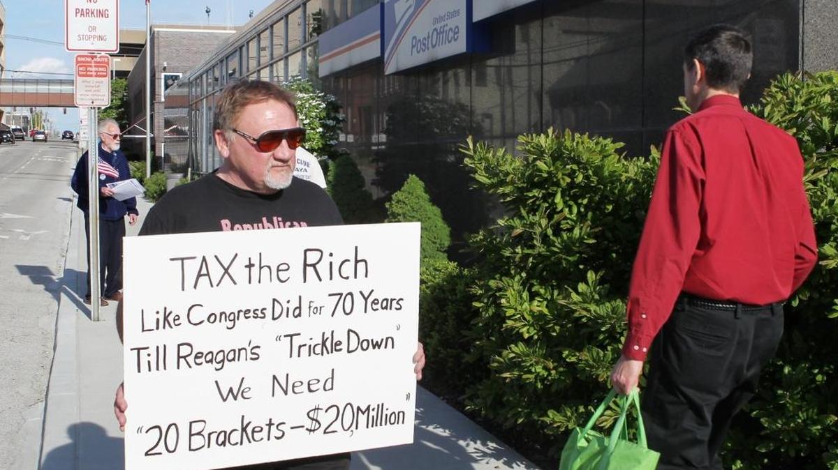 James Hodgkinson of Belleville protests outside of the United States Post Office in Downtown Belleville in this file photo. Hodgkinson is part of the “99%” team drawing attention to the disproportionate amount of money and political power the top 1 percent of Americans have acquired. Also protesting outside of the post office where members of the Communications Workers of America Local 4217 they were drawing attention to the low percentage of taxes paid by AT&T.