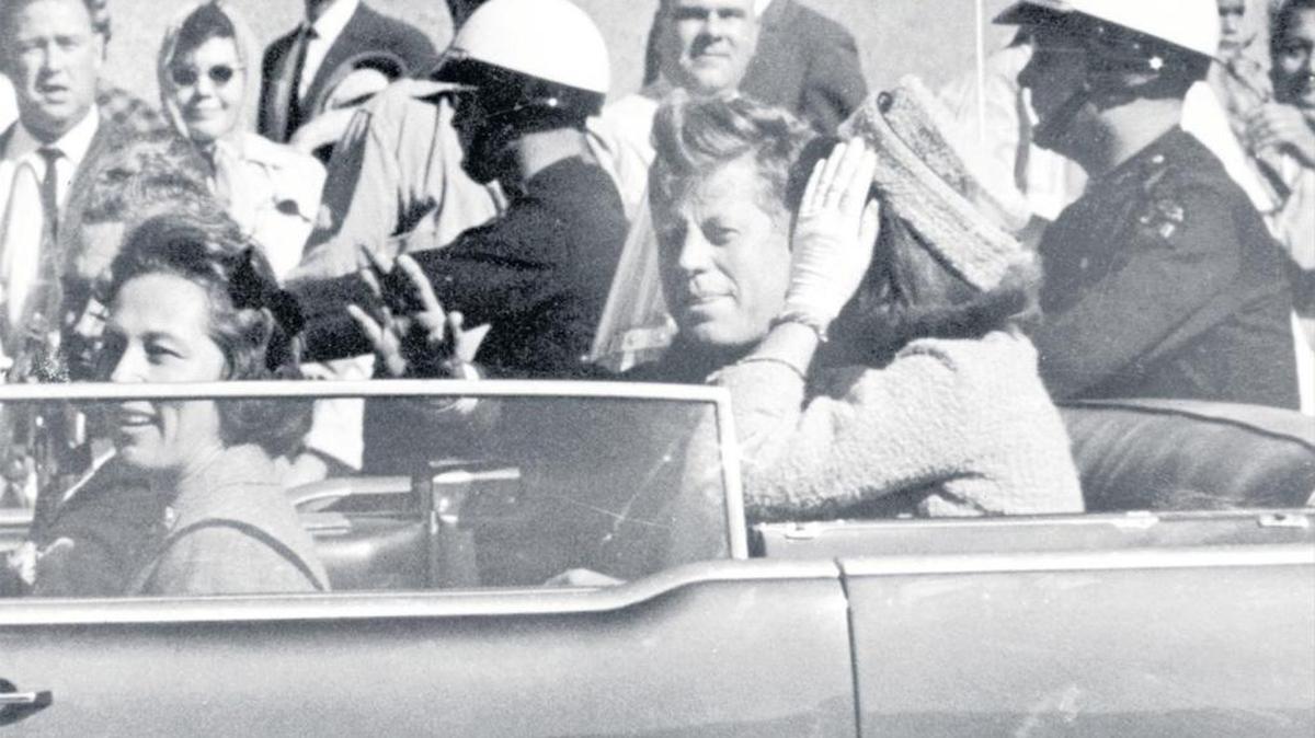 In this Nov. 22, 1963 file photo, President John F. Kennedy waves from his car in a motorcade in Dallas. Riding with Kennedy are First Lady Jacqueline Kennedy, right, Nellie Connally, second from left, and her husband, Texas Gov. John Connally, far left.
