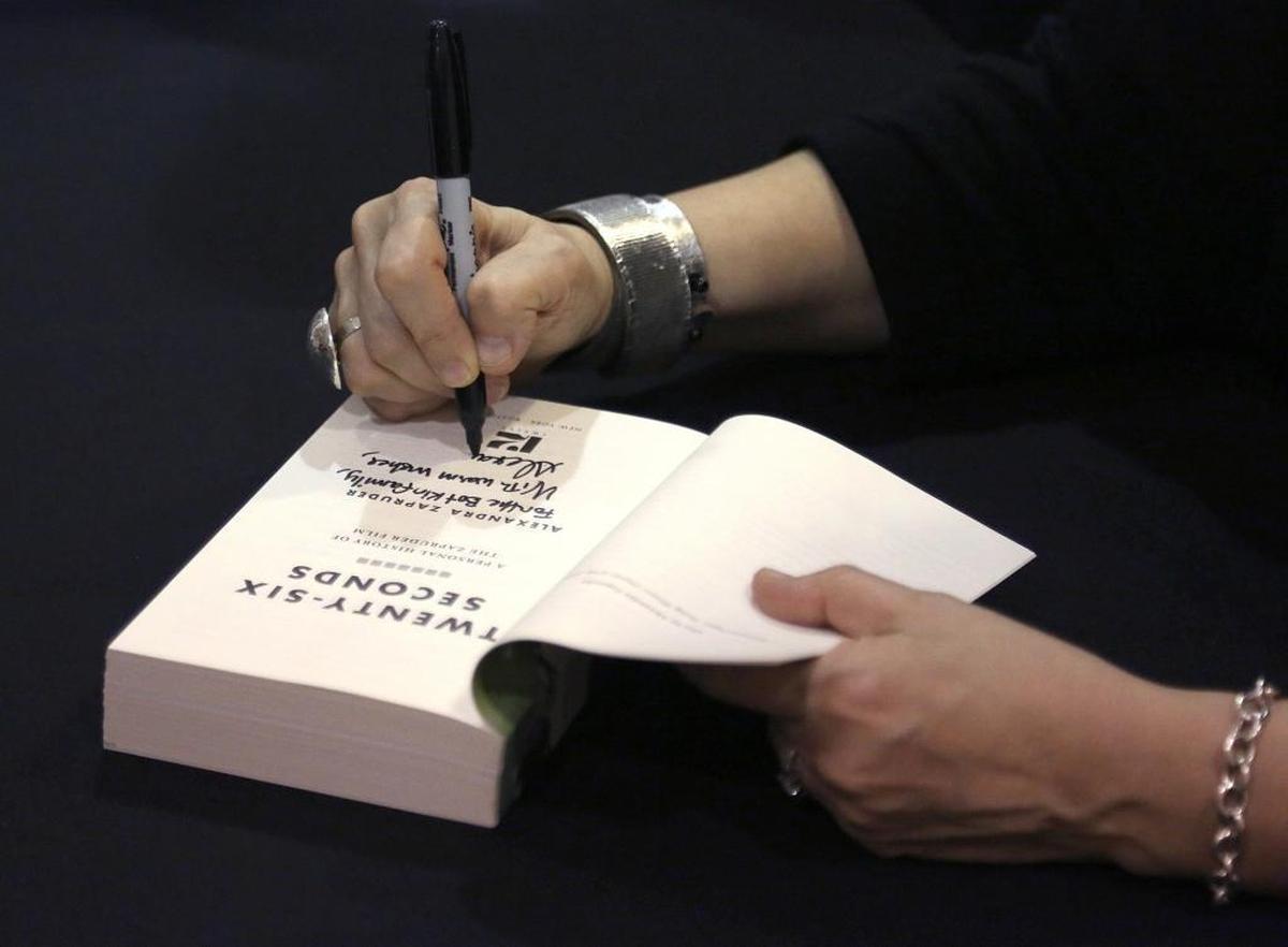 Alexandra Zapruder, granddaughter of the Abraham Zapruder who filmed the JFK assassination, signs copies of her book.