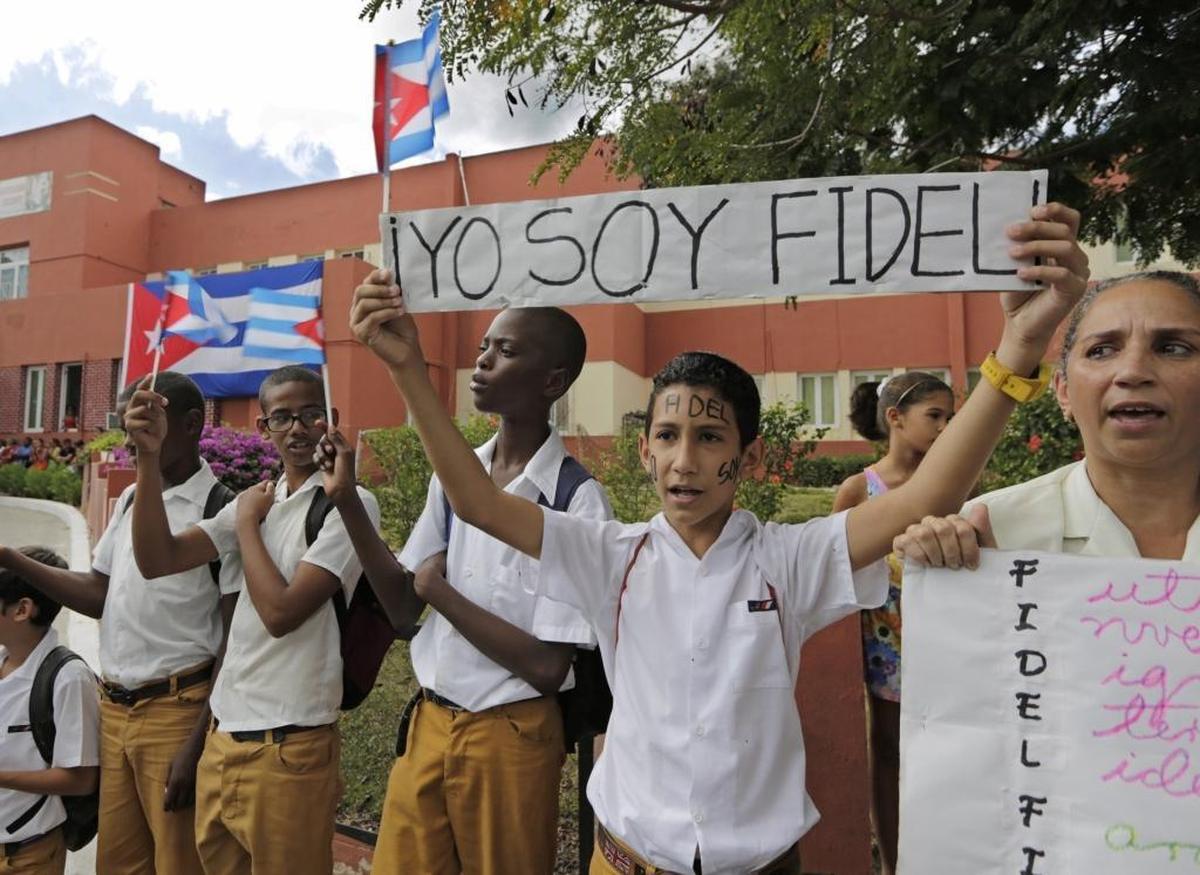 School children wait for the passage of Fidel Castro's ashes outside a clinic on the route to the Moncada Barracks, in Santiago de Cuba last year.