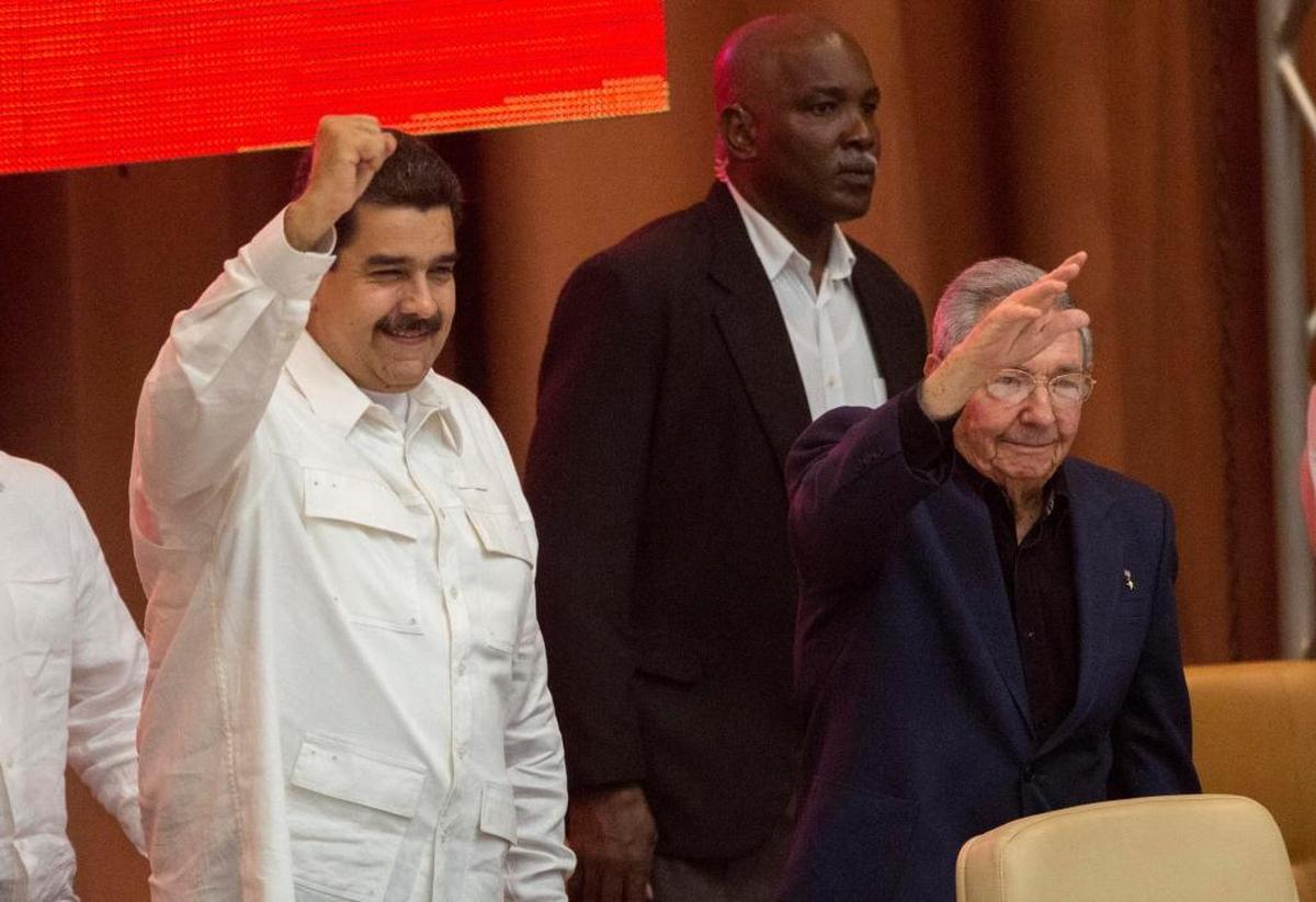 Cuba's President Raul Castro, right, and Venezuela's President Nicolas Maduro gesture after a session of the XIII anniversary celebration of the founding of the Bolivarian Alliance for the Americas (ALBA) in Havana, Cuba, Thursday, Dec. 14, 2017.