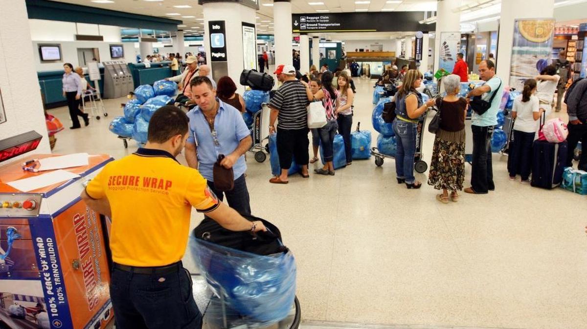 Passengers at Miami International Airport await a flight to Cuba.