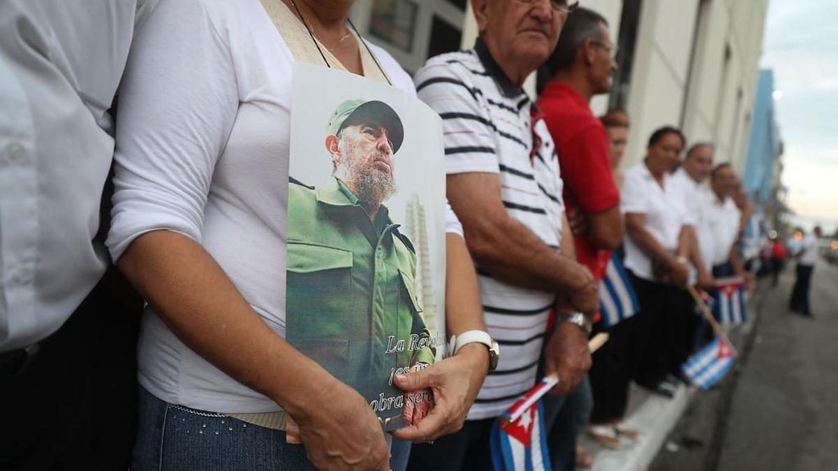 People line the street to watch the convoy of vehicles escorting the remains of Fidel Castro during a journey across the country to Santiago de Cuba where he will be buried Sunday.