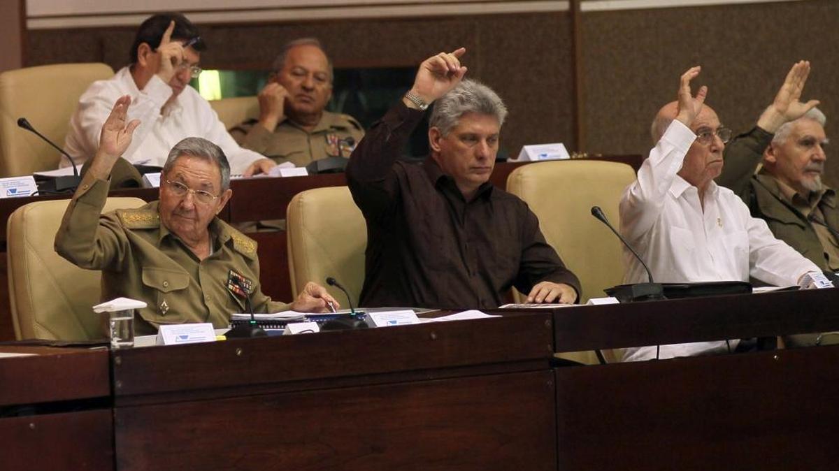 Changing of the guard: Raúl Castro is shown with Miguel Díaz-Canel, center, secondand José Ramón Machado Ventura, second from right, . The trio are shown during a National Assembly session on March 29, 2014.