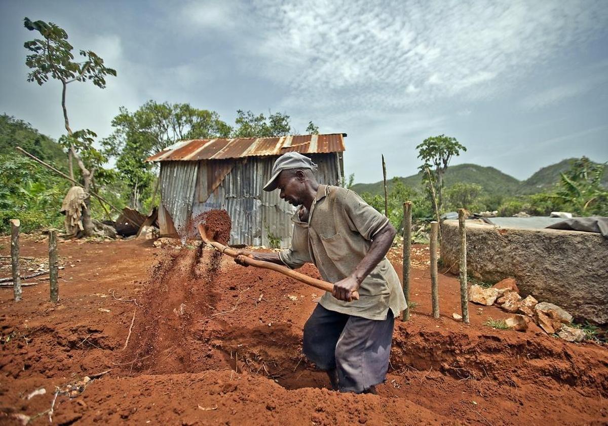 One of several men working on a site just off the desolated highway leading into the Grand'Anse. With its cement blocks and clay-colored mud, the construction site was an oddity in a region, where despite shiny new aluminum roofs dotting the once more green landscape, most homes remain in disrepair, their inhabitants living with family and friends.
