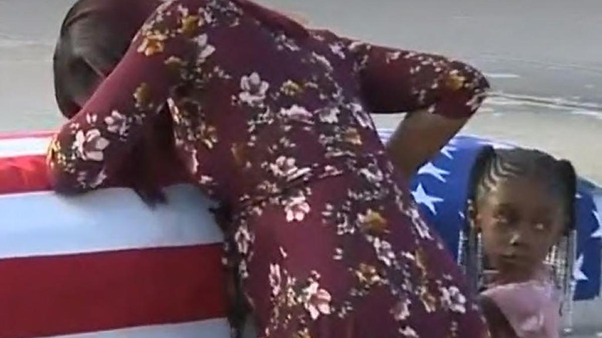 Myeshia Johnson, the widow of fallen Miami Gardens soldier Sgt. La David T. Johnson, who was killed in an ambush in Niger in west Africa earlier this month, cries atop the casket with his body at Miami International Airport, Oct. 17, 2017.