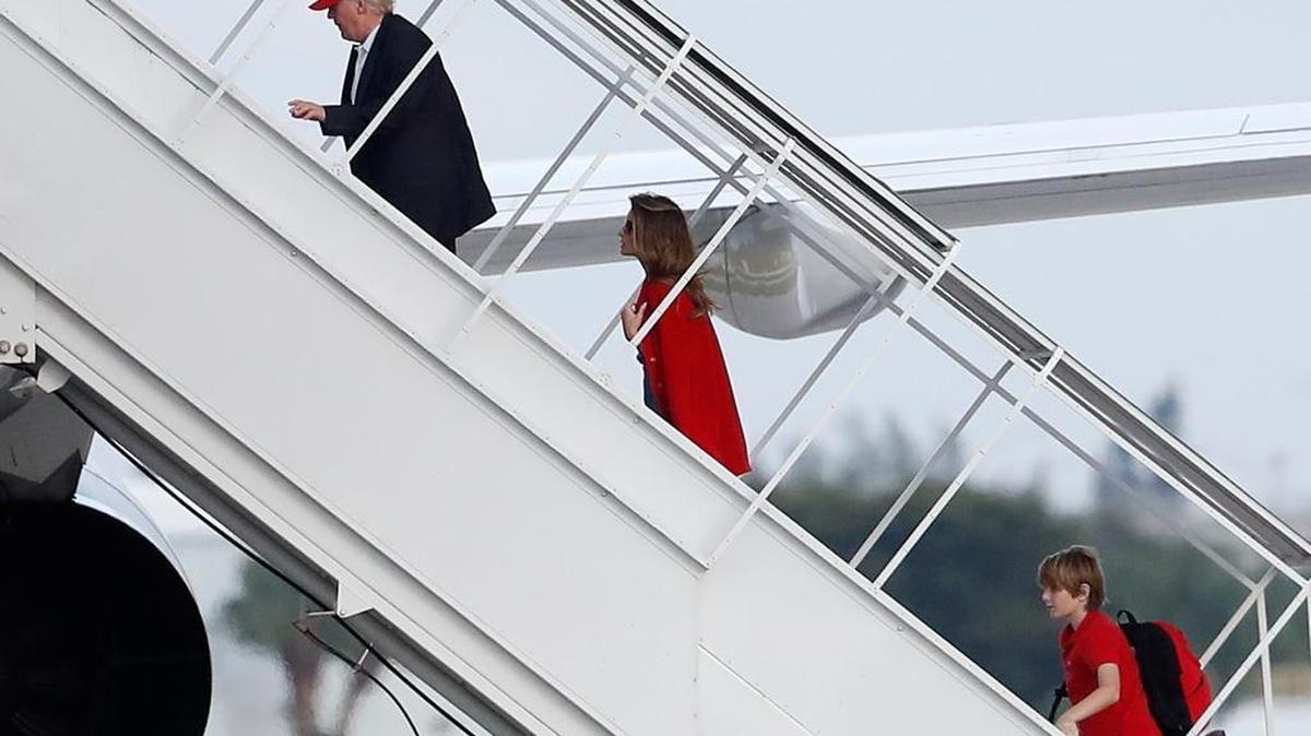 President-elect Donald Trump, followed by his wife Melania Trump and son Barron Trump, boards his plane Palm Beach International Airport on Sunday.