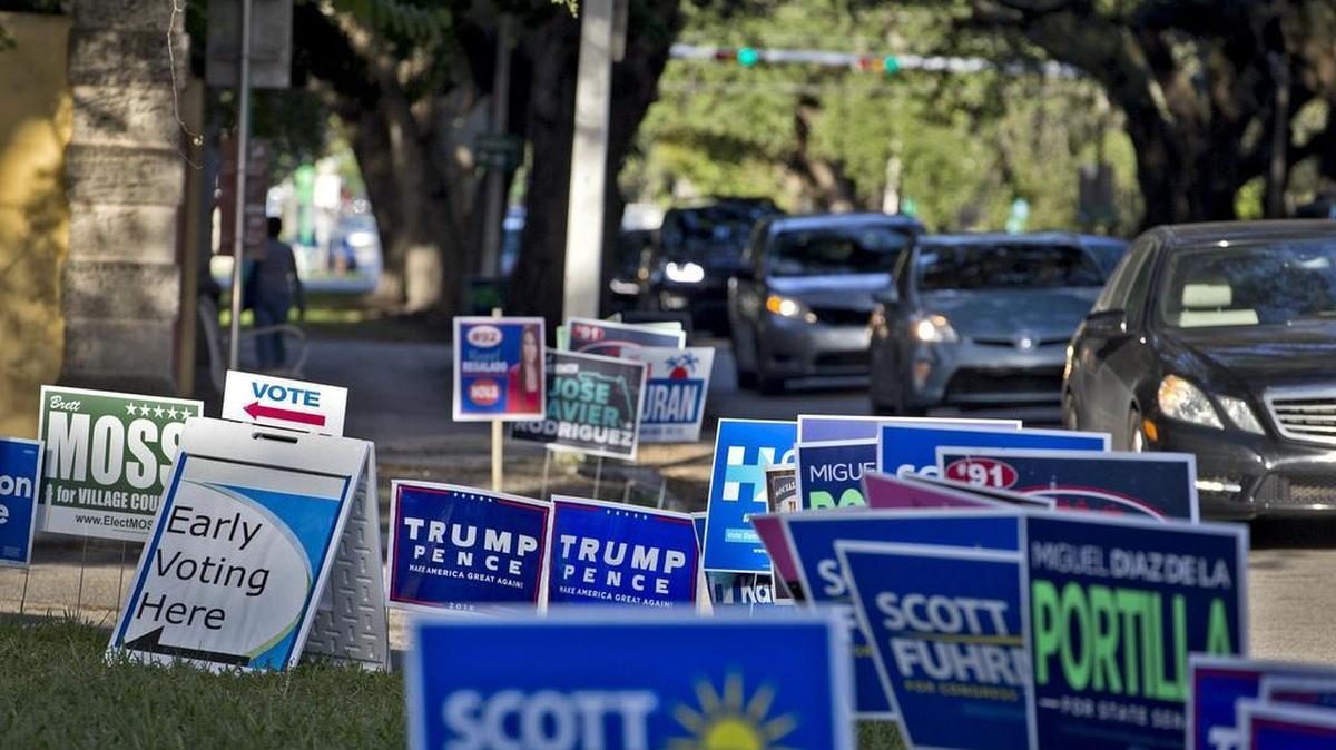 Campaign signs greet rush-hour drivers as they head home from work on South Bayshore drive past the Vizcaya Garage early voting location on Wednesday, November 2, 2016, in Coconut Grove.