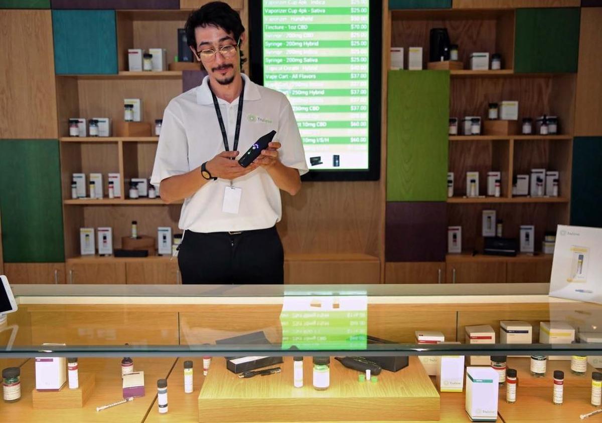 Andy Luis, a patient consultant at Trulieve, Miami’s first retail medical marijuana dispensary located near Miami International Airport, exhibits a vaporizer that can be used with products sold at this store.