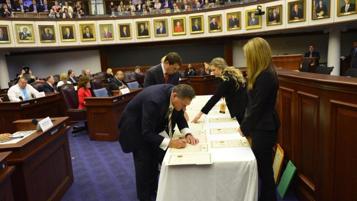 Presidential electors state Rep. Larry Ahern, R-Seminole, and Tallahassee lobbyist Brian Ballard sign certificates of vote after the state's 29 members of the electoral college cast their votes for Donald Trump.