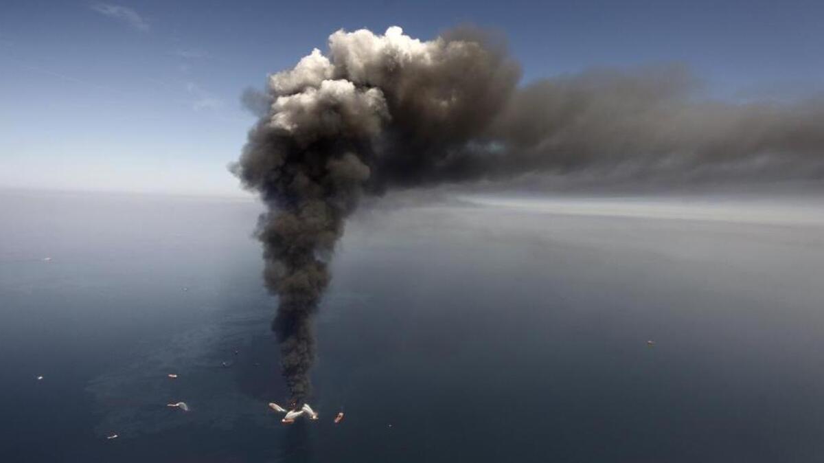 In this April 21, 2010, file photo shows a large plume of smoke rising from BP's Deepwater Horizon offshore oil rig in the Gulf of Mexico.