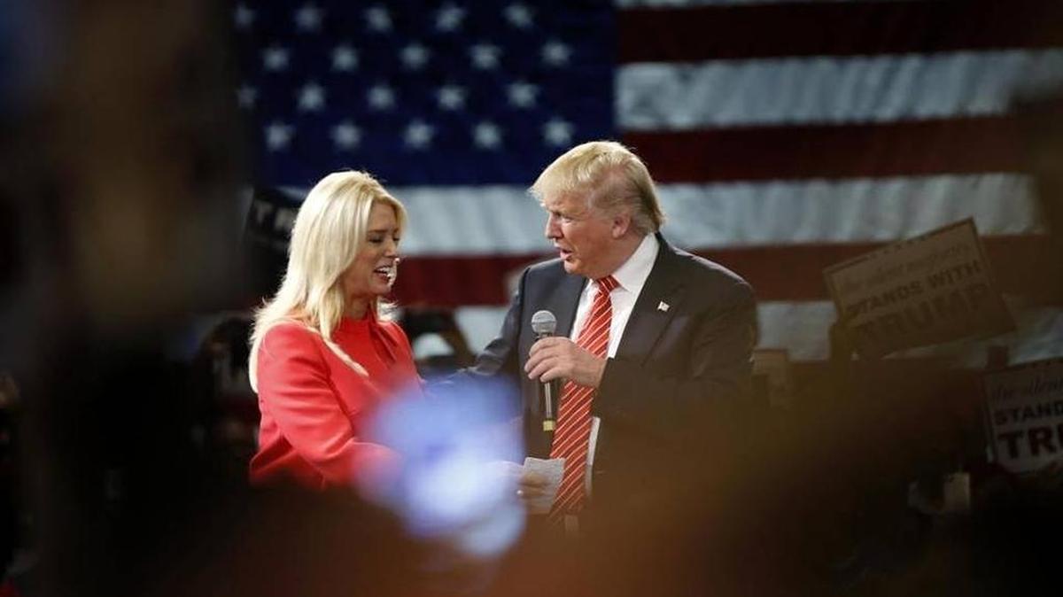 Republican presidential candidate Donald Trump is greeted by Florida Attorney General Pam Bondi as she introduces him to speak at a campaign event in Tampa on March 14, 2016. She is scheduled to give a five-minute address at the Republican National Convention at 8:30 p.m. Wednesday.