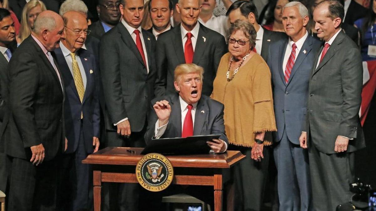 President Donald Trump signs his Cuba policy at the Manuel Artime Theater in Miami on Friday, June 16, 2017.